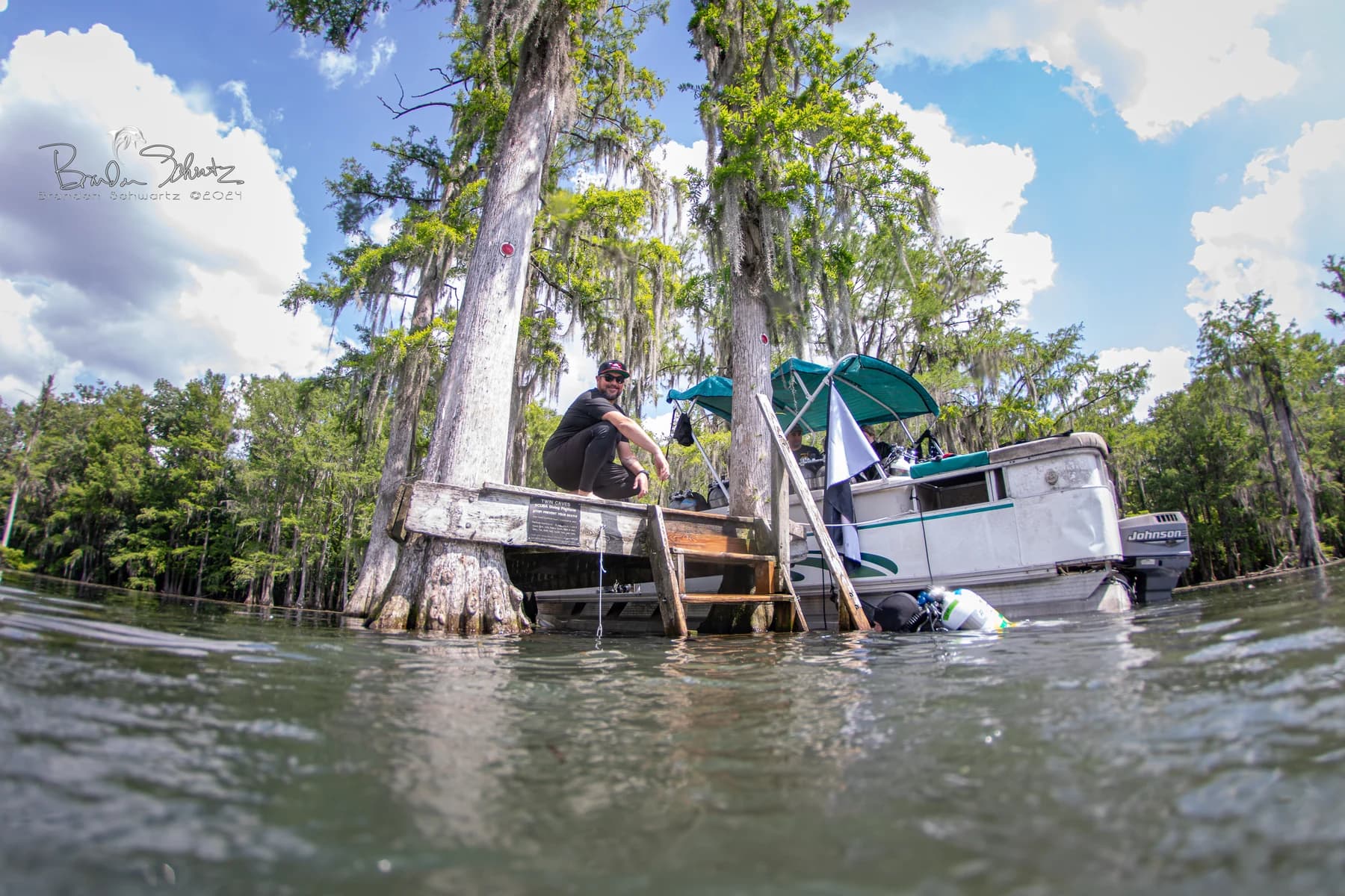 Jay Gardner beside the boat at the Twin Caves surface entry